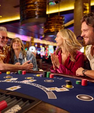 Two couples playing Blackjack